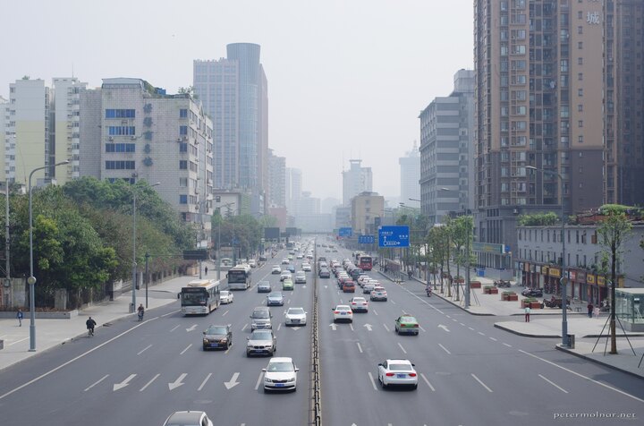 A view road with light traffic in Chengdu during the day - there is
both humidity and smog in the air