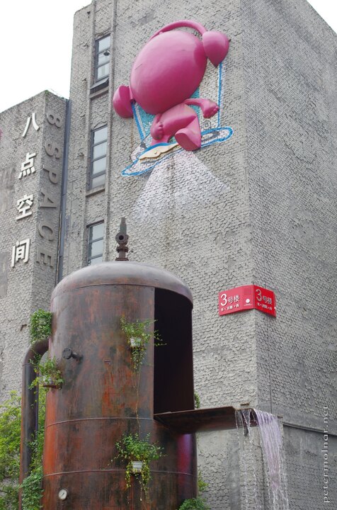 Another view of the fountain at the Easter Suburb Memory including one
of the mascots of the place on the
wall